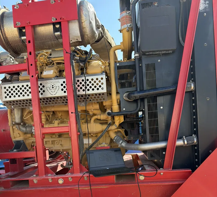 Diagnostics with a laptop on a Scania V8 pump unit in the field.
