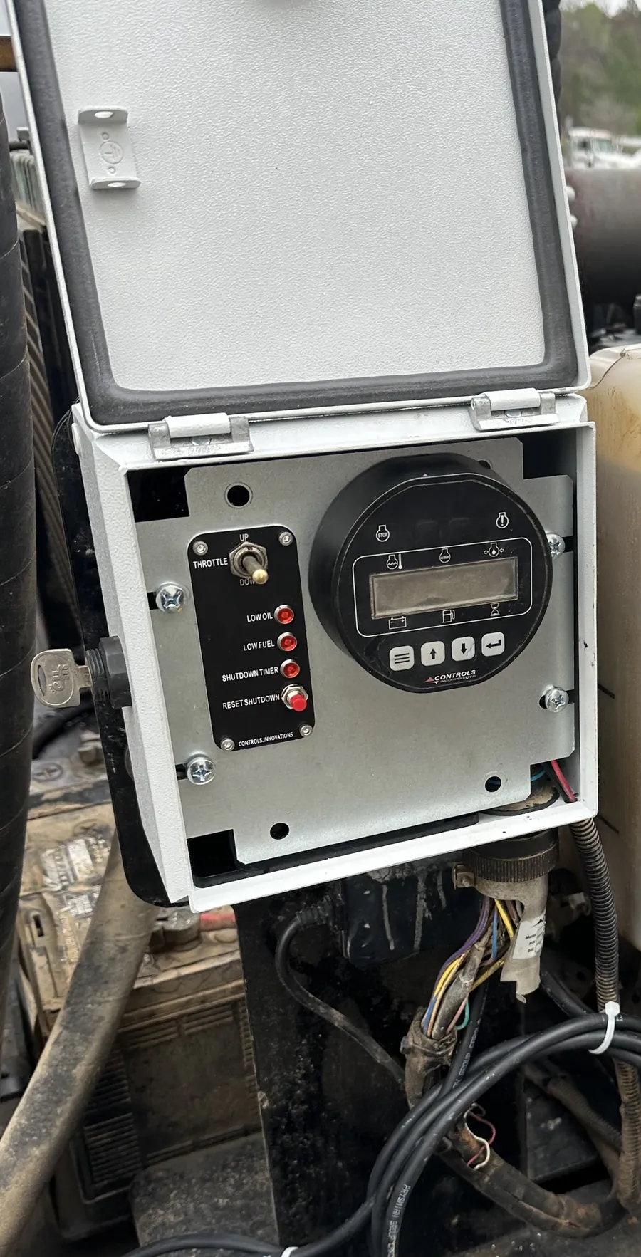 A smart relay control panel mounted on an engine.
