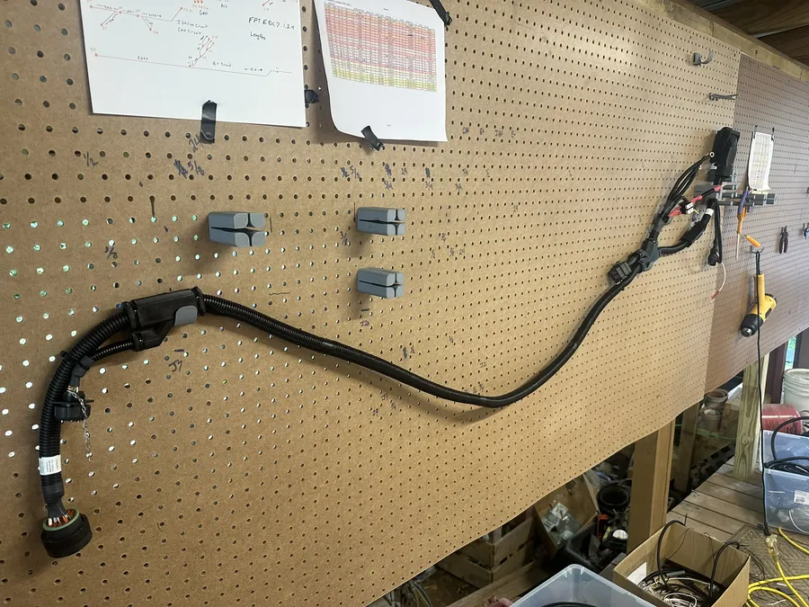 A new wiring harness for an FPT Cursor 13 engine laid out on the board.